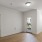 a room with a wood floor and white walls