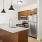 a kitchen with a stainless steel refrigerator